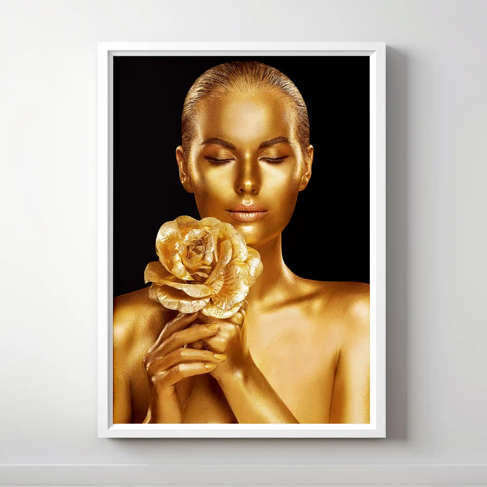 Abstract portrait of a woman with gold body paint and golden rose.