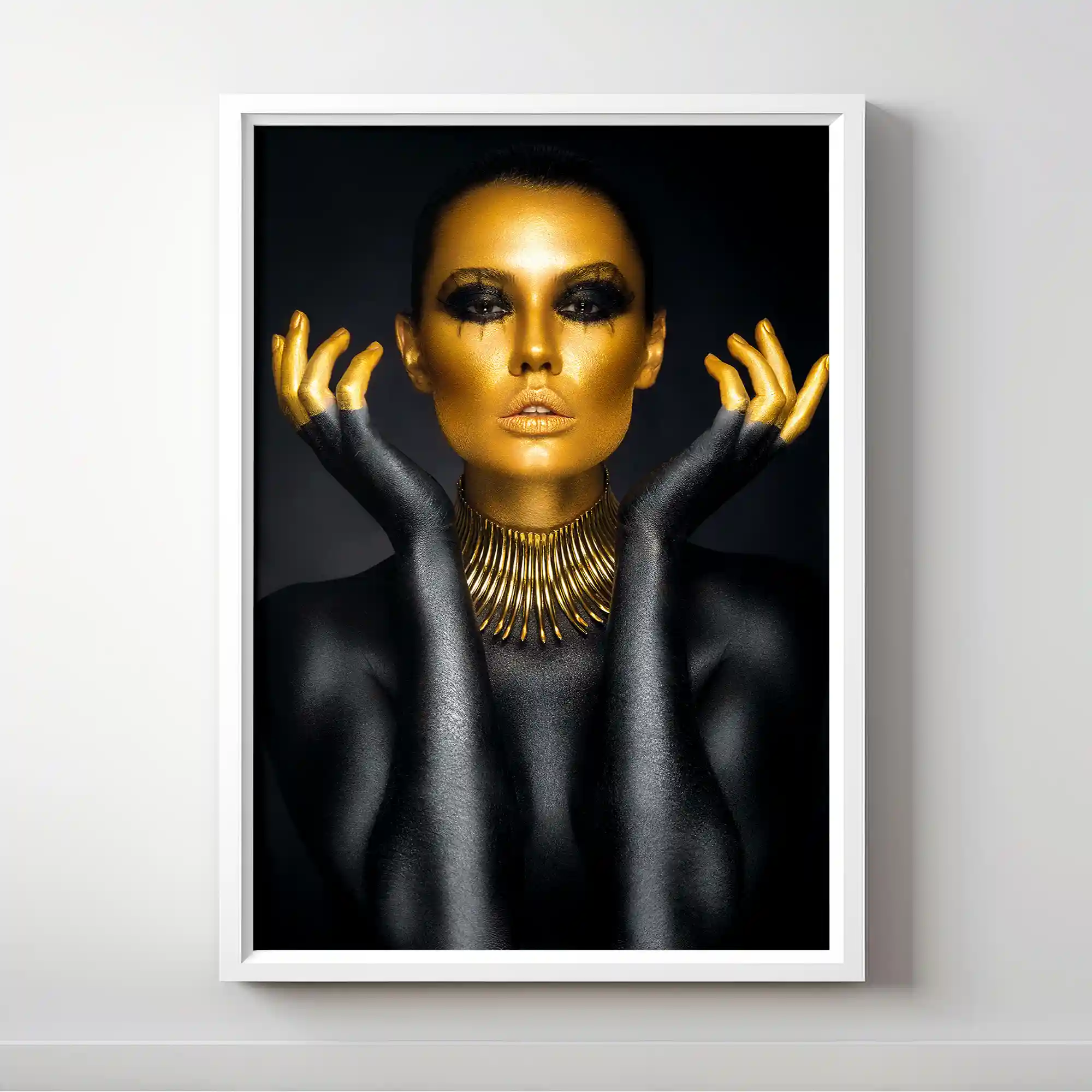 Abstract portrait of a woman with gold body paint and jewelry.