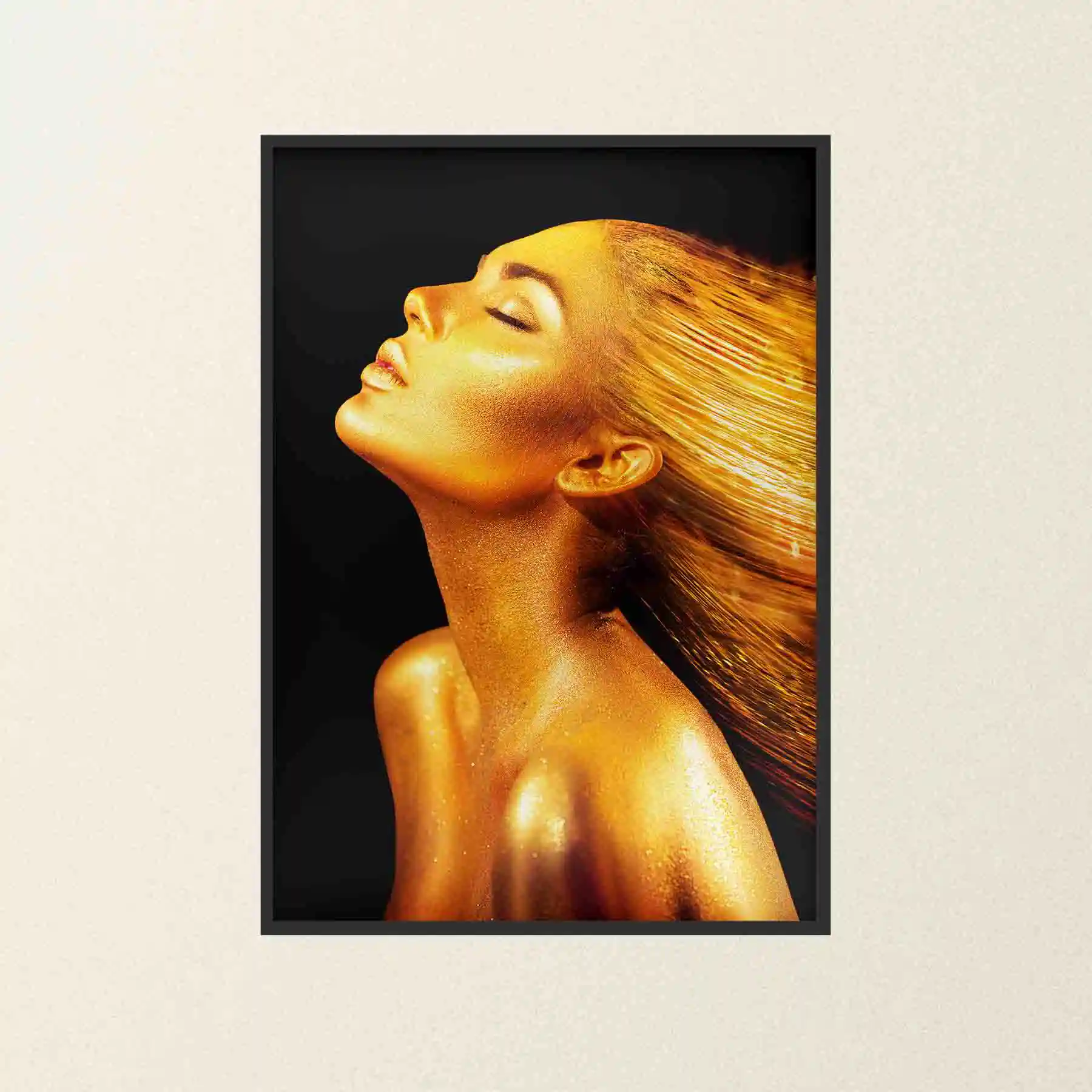 Abstract portrait of a woman with gold body paint and flowing hair.