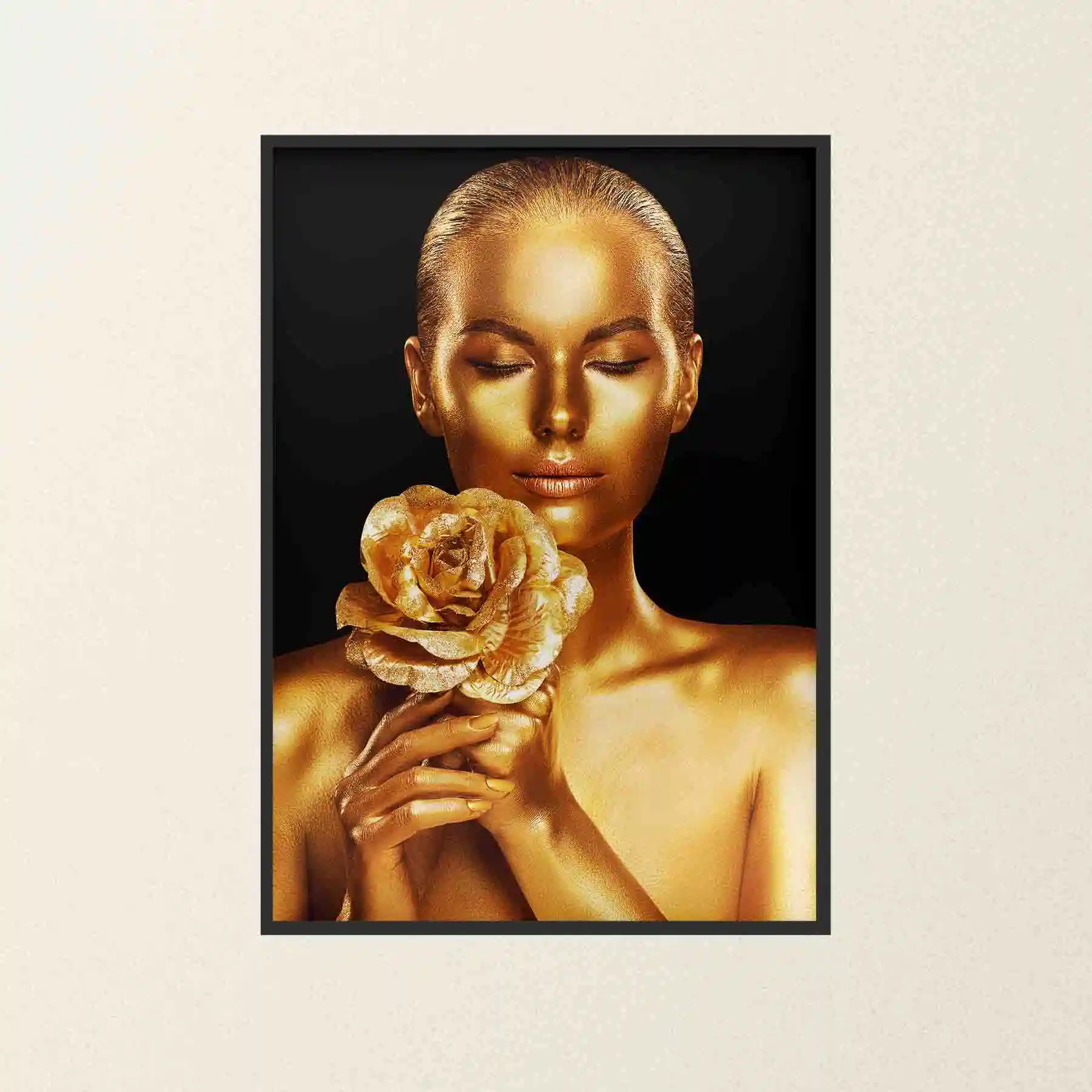 Abstract portrait of a woman with gold body paint and golden rose.