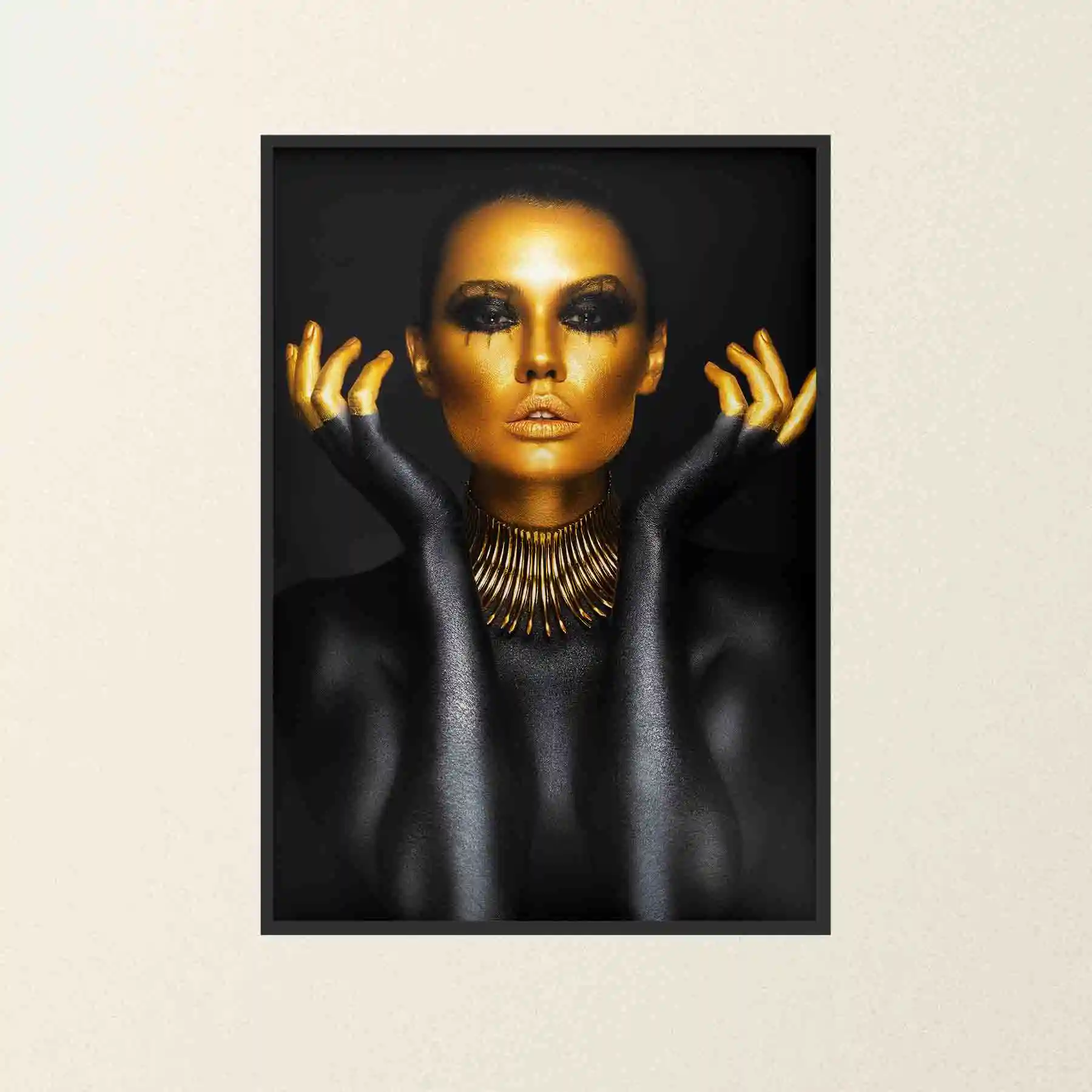 Abstract portrait of a woman with gold body paint and jewelry.