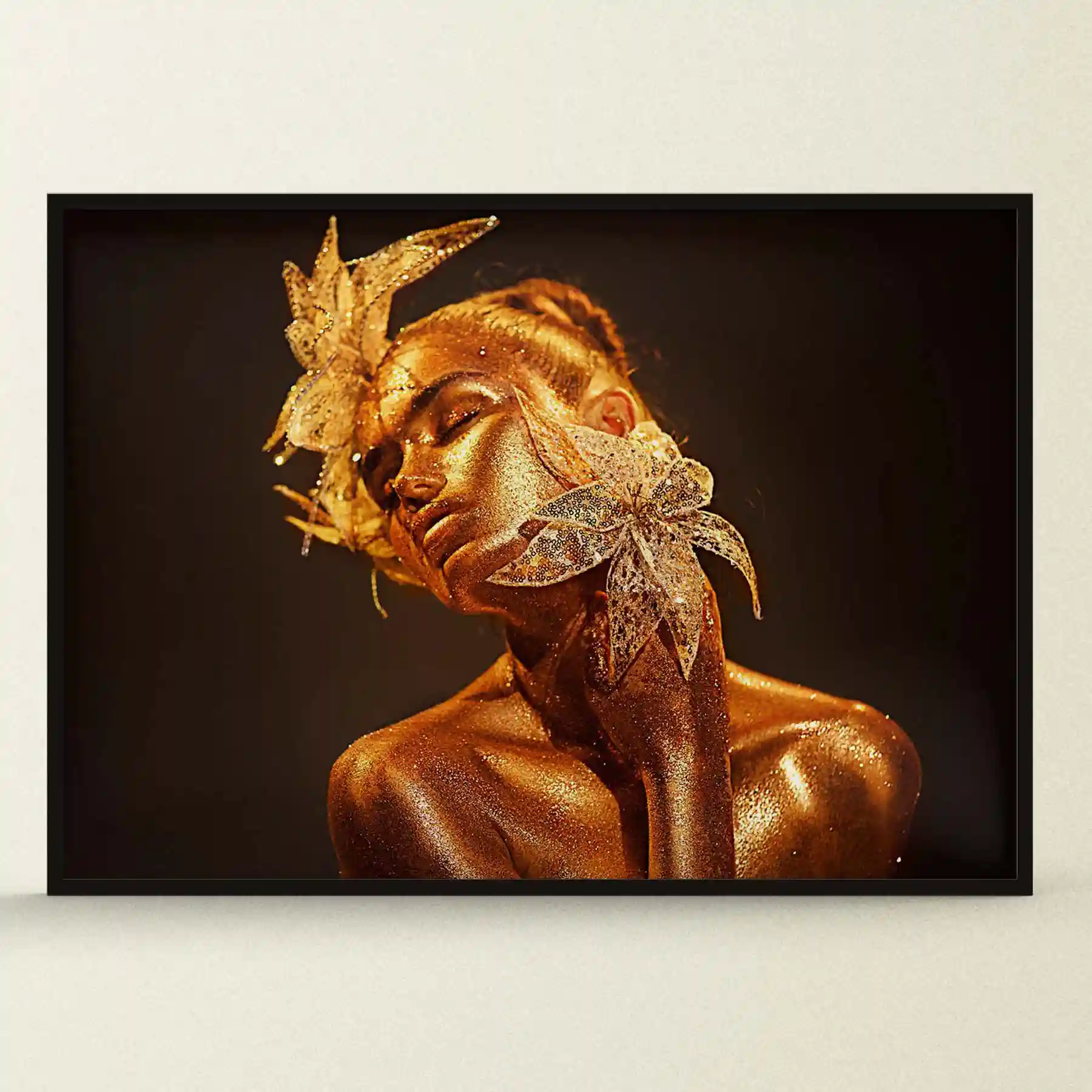 Abstract portrait of a woman with gold face paint and dark background.