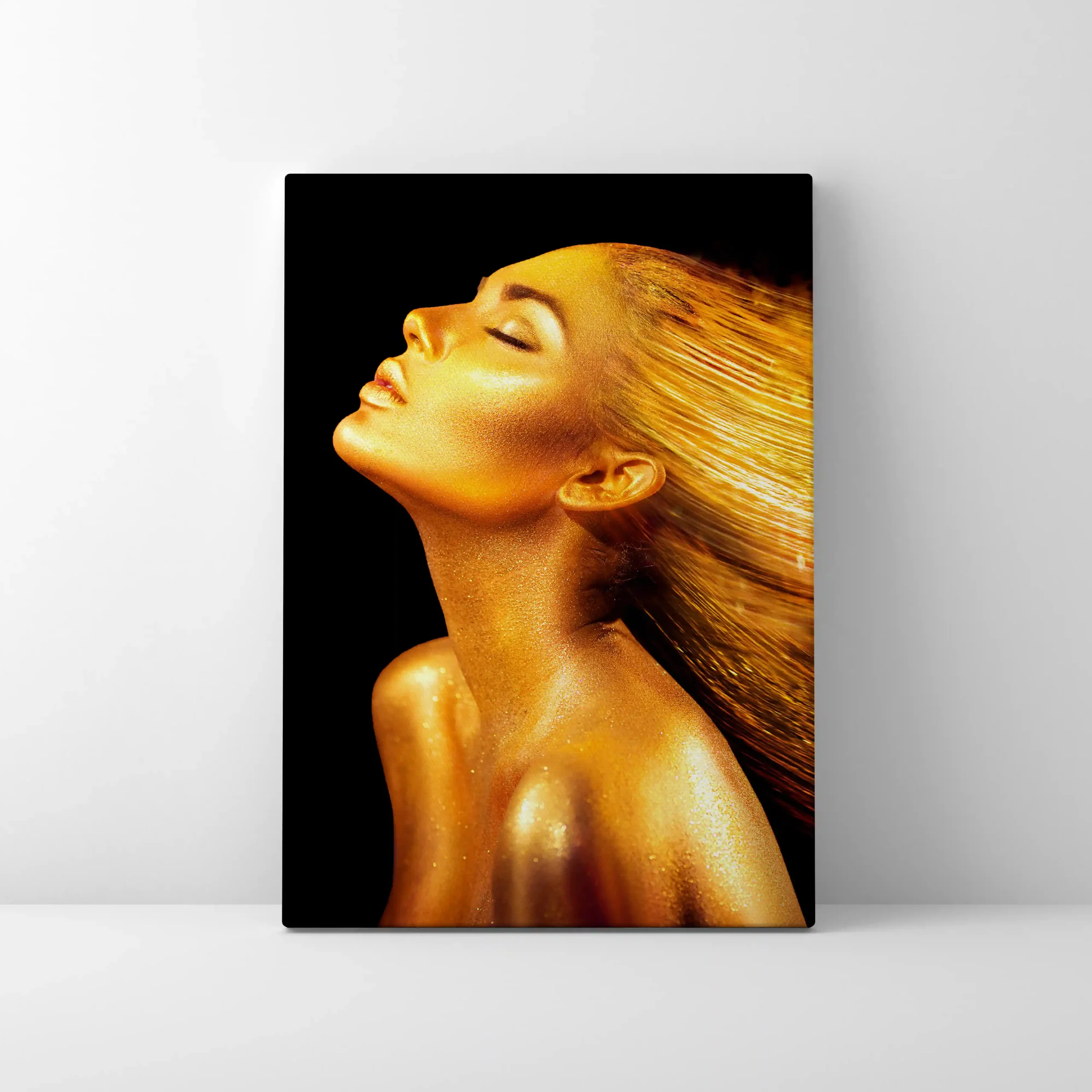 Abstract portrait of a woman with gold body paint and flowing hair.