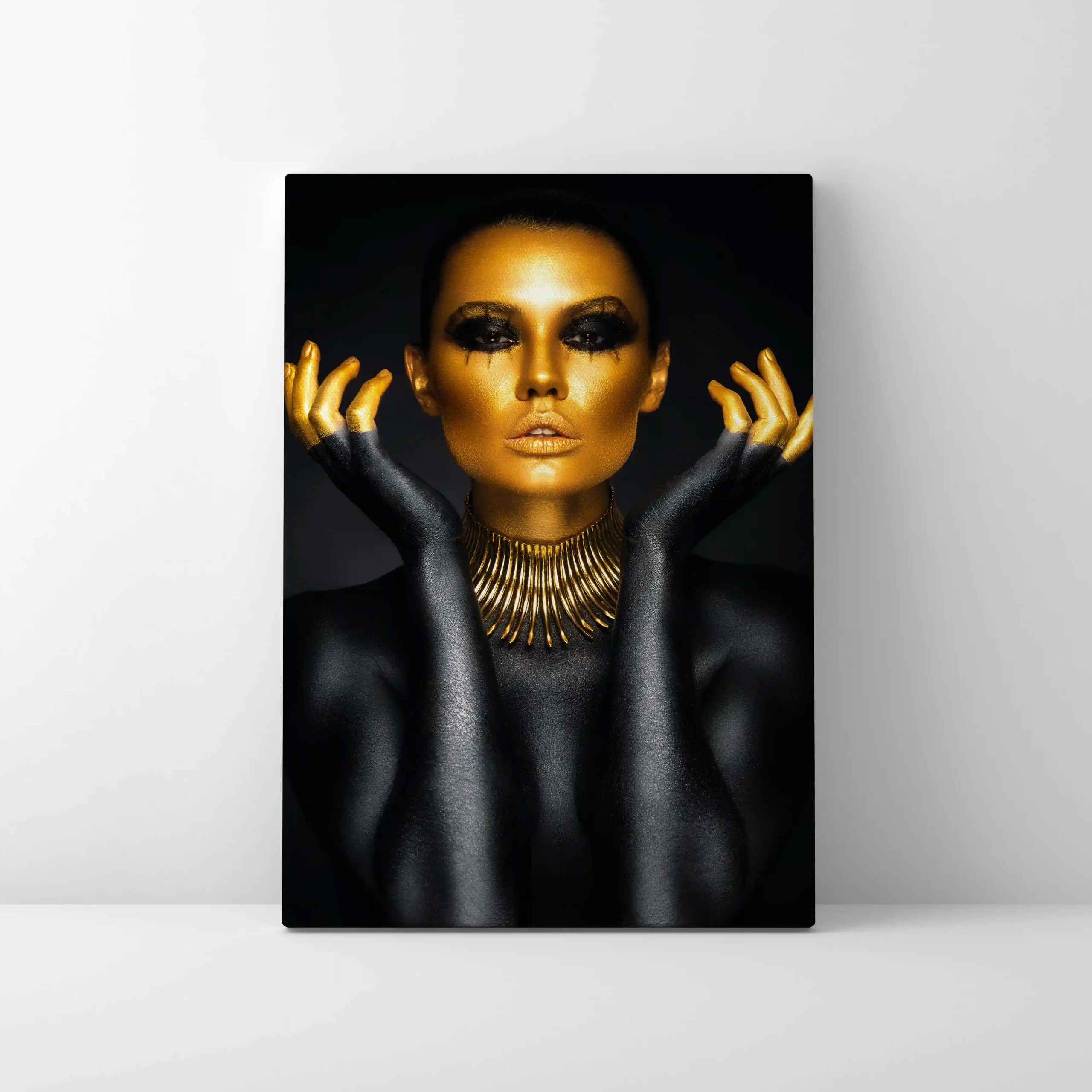 Abstract portrait of a woman with gold body paint and jewelry.