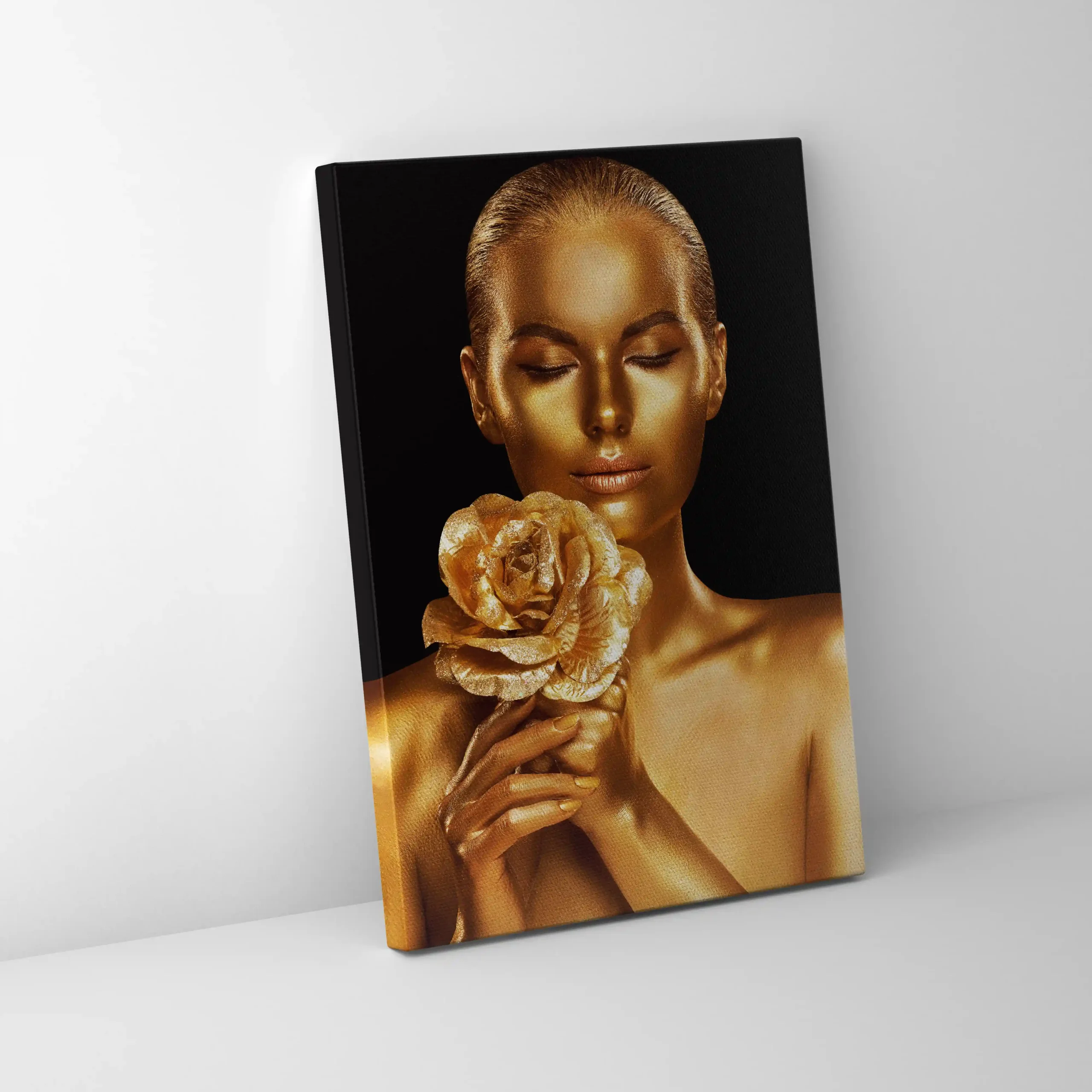 Abstract portrait of a woman with gold body paint and golden rose.