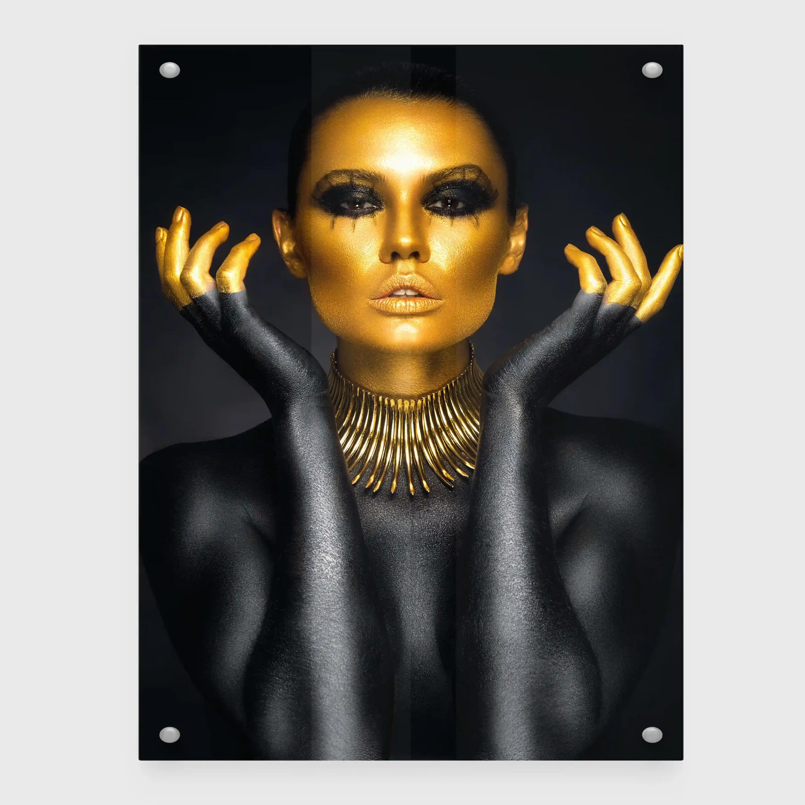 Abstract portrait of a woman with gold body paint and jewelry.